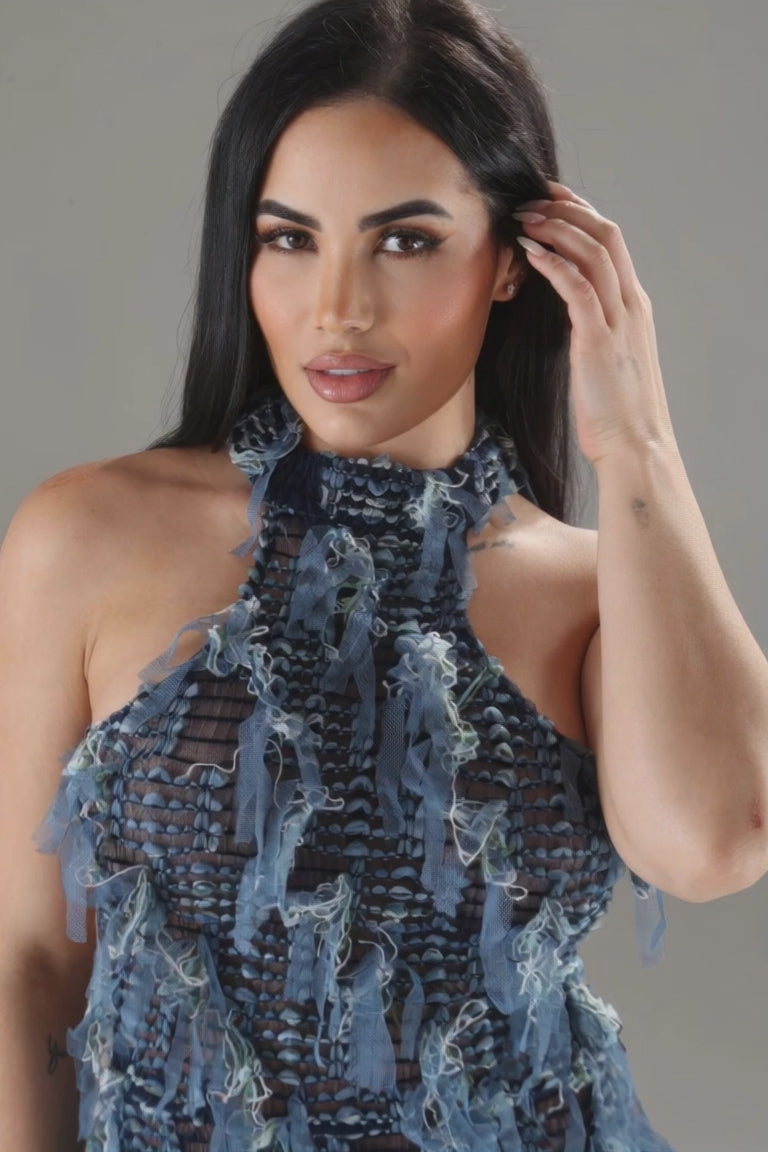 video photoshoot at unique kultureModel wearing Unique Kulture blue halter ruffled dress with open back and multi-ruffles blue version close up