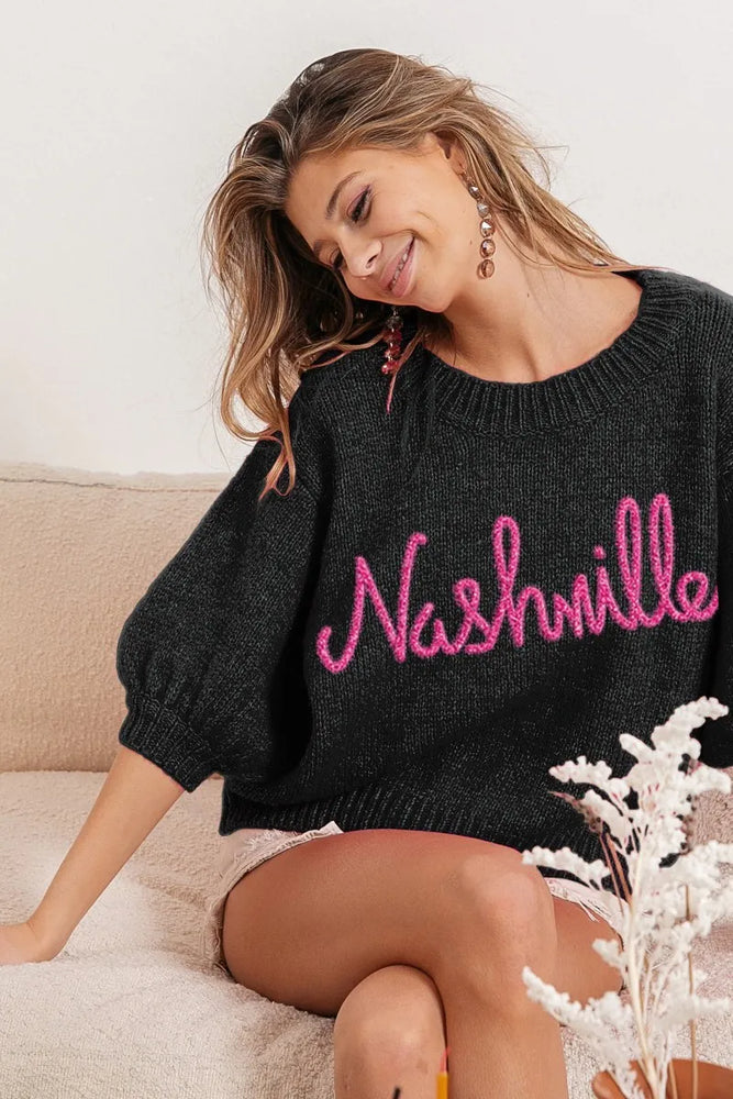 Woman wearing a BiBi Metallic Letter Short Puff Sleeve Hairy Sweater with shimmering metallic letters and fuzzy texture, styled for a trendy, cozy statement look.

