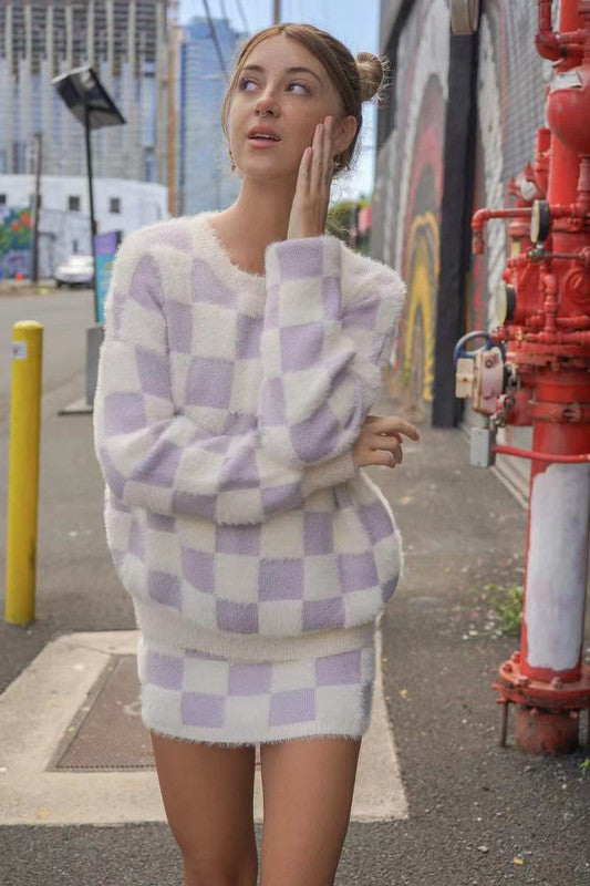 Model wearing Unique Kulture luxury fuzzy checkered mini skirt
 whole out fit pic
