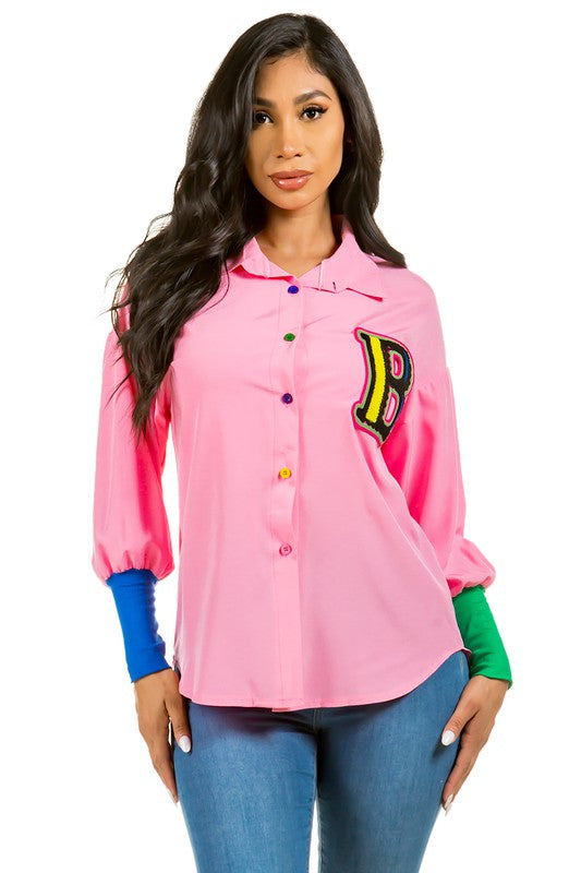 Model wearing Unique Kulture luxury sexy fashion top with long sleeves, color button, and high-low hem

 pink 