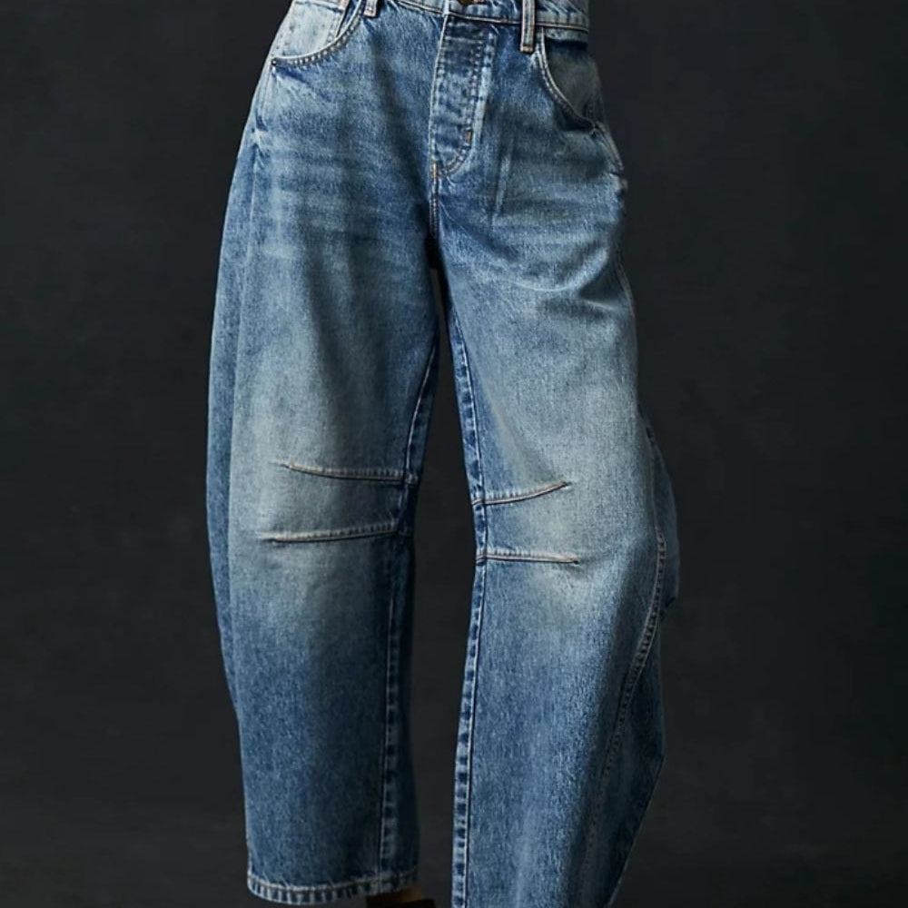 Front view of the Unique Kulture Candy Wide Leg Jeans with Pockets, featuring a classic buttoned closure, a flattering wide leg silhouette, and practical pockets. The jeans are made from a high-quality blend of cotton and polyester, showcasing a stylish and comfortable design perfect for everyday wear.
