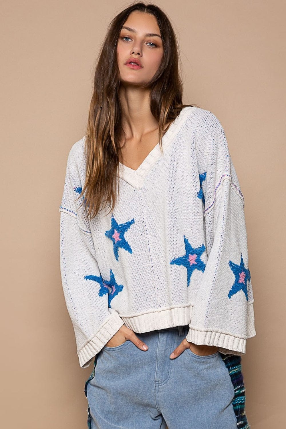 Trendy V-Neck Long Sleeve Sweater featuring unique details such as a color-blocked star berber patch, out seam design, and rib band point. The sweater is displayed on a neutral background, showcasing its stylish and modern silhouette, perfect for casual wear and everyday comfort\