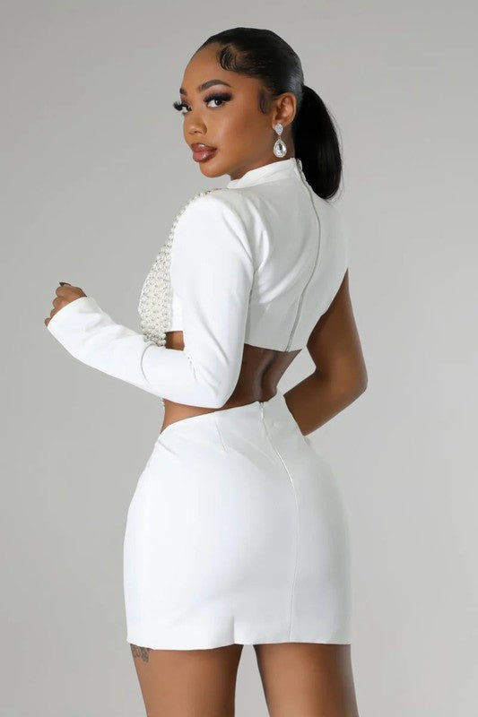 
                  
                    Model wearing Unique Kulture luxury one-shoulder mini party dress with long sleeve and cut-off detail

 white back view
                  
                