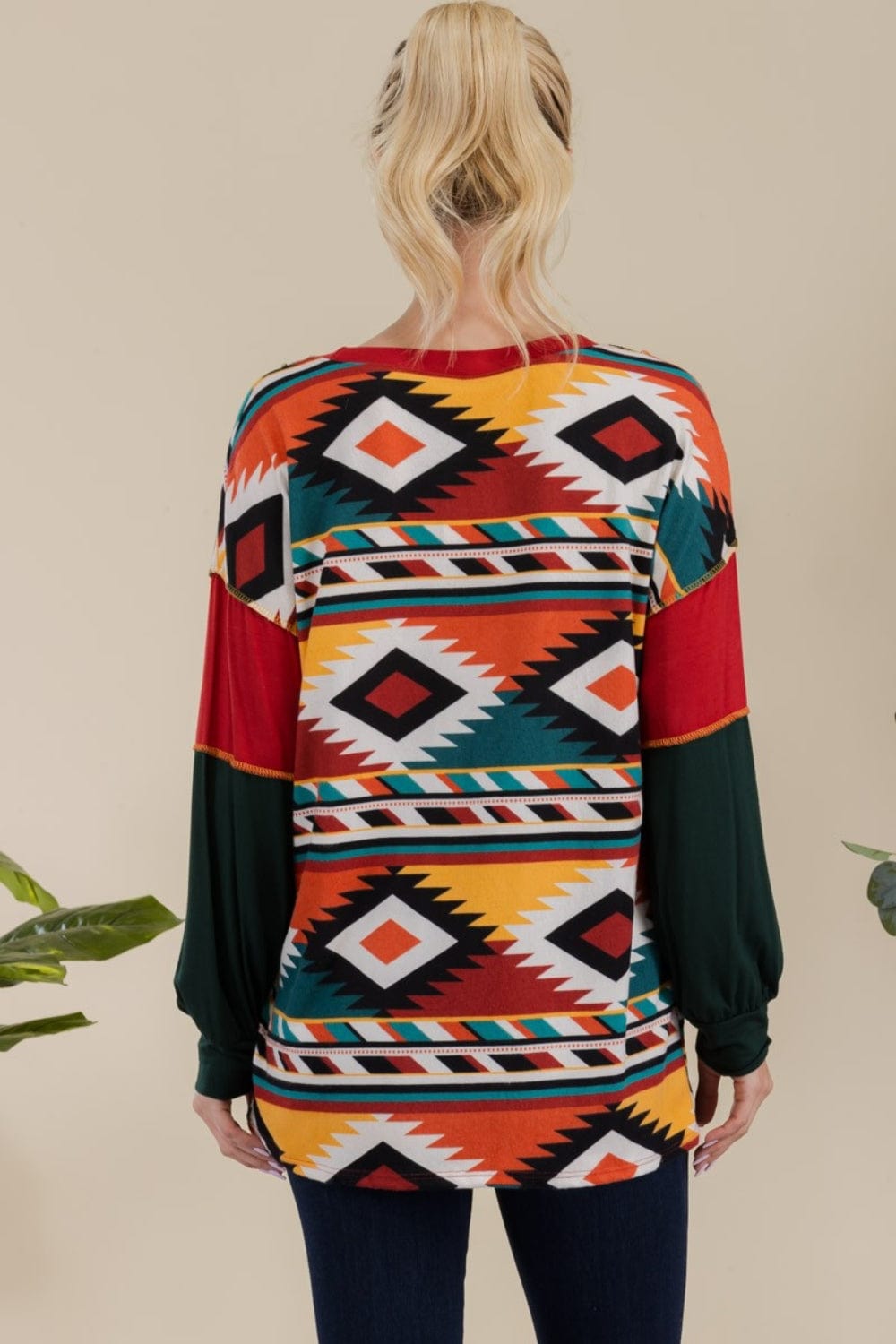 "back view of the Celeste Full Size Exposed Seam Print Color Block T-Shirt, showcasing its vibrant contrasting colors and modern exposed seam design. The t-shirt features a slightly stretchy fit and an opaque fabric, perfect for a stylish and comfortable casual look