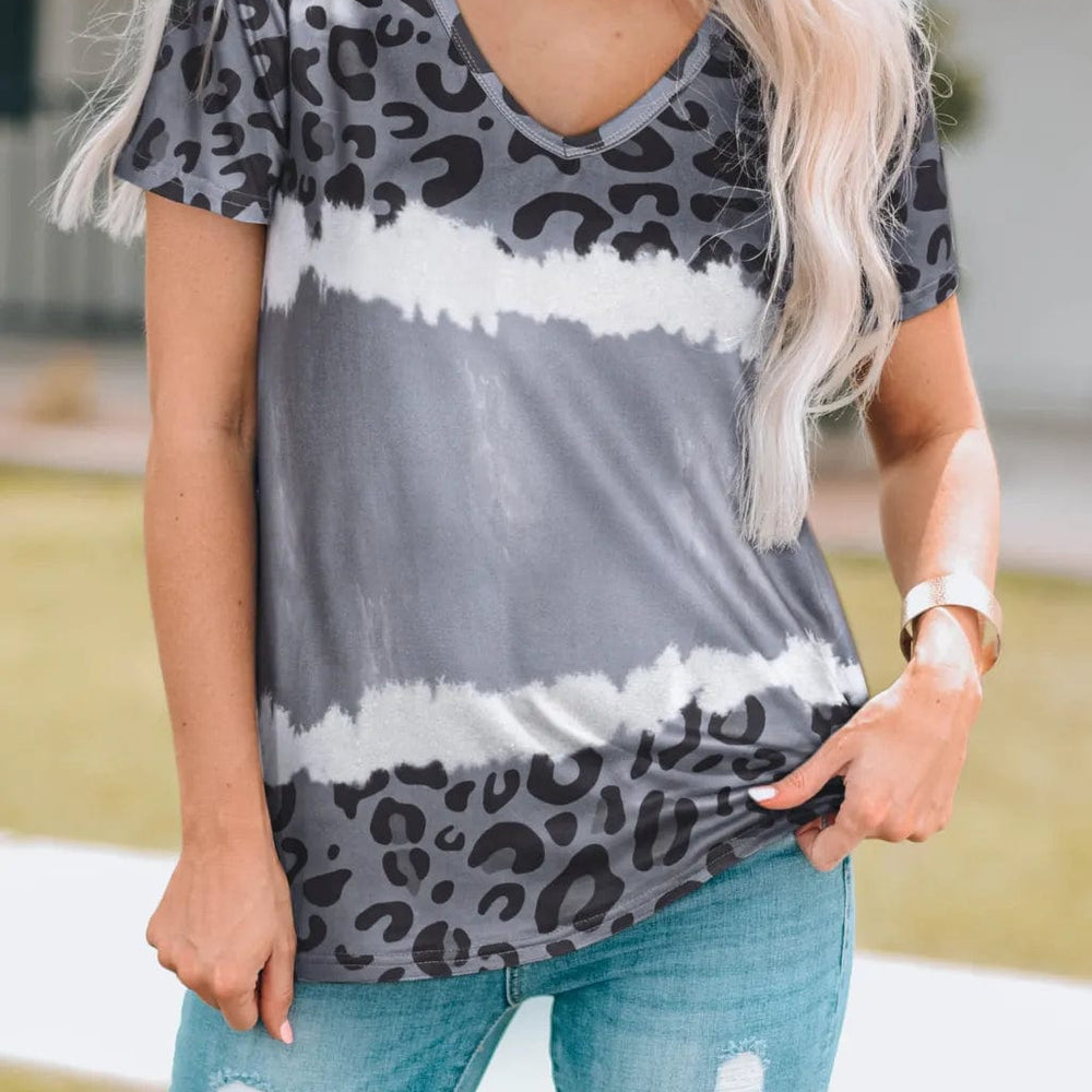 Front view of the Unique Kulture Leopard V-Neck Short Sleeve T-Shirt, featuring a bold leopard print design and a flattering v-neckline. The shirt showcases short sleeves and a relaxed fit, made from soft, opaque fabric, perfect for casual wear
