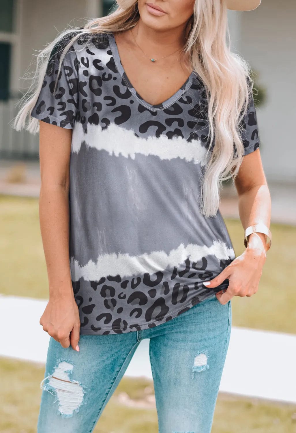 Front view of the Unique Kulture Leopard V-Neck Short Sleeve T-Shirt, featuring a bold leopard print design and a flattering v-neckline. The shirt showcases short sleeves and a relaxed fit, made from soft, opaque fabric, perfect for casual wear
