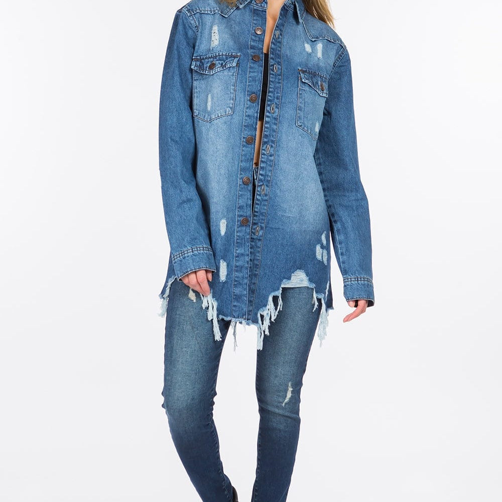 Unique Kulture Distressed Frayed Hem Denim Jacket featuring a classic denim silhouette with distressed detailing and a raw frayed hem. The jacket is shown in a stylish, casual setting, highlighting its edgy design and versatility for layering over various outfits
