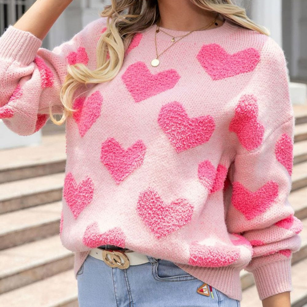 "Heart Jacquard Round Neck Sweater featuring a playful heart pattern, displayed on a mannequin against a neutral backdrop, showcasing its cozy fit and stylish design."