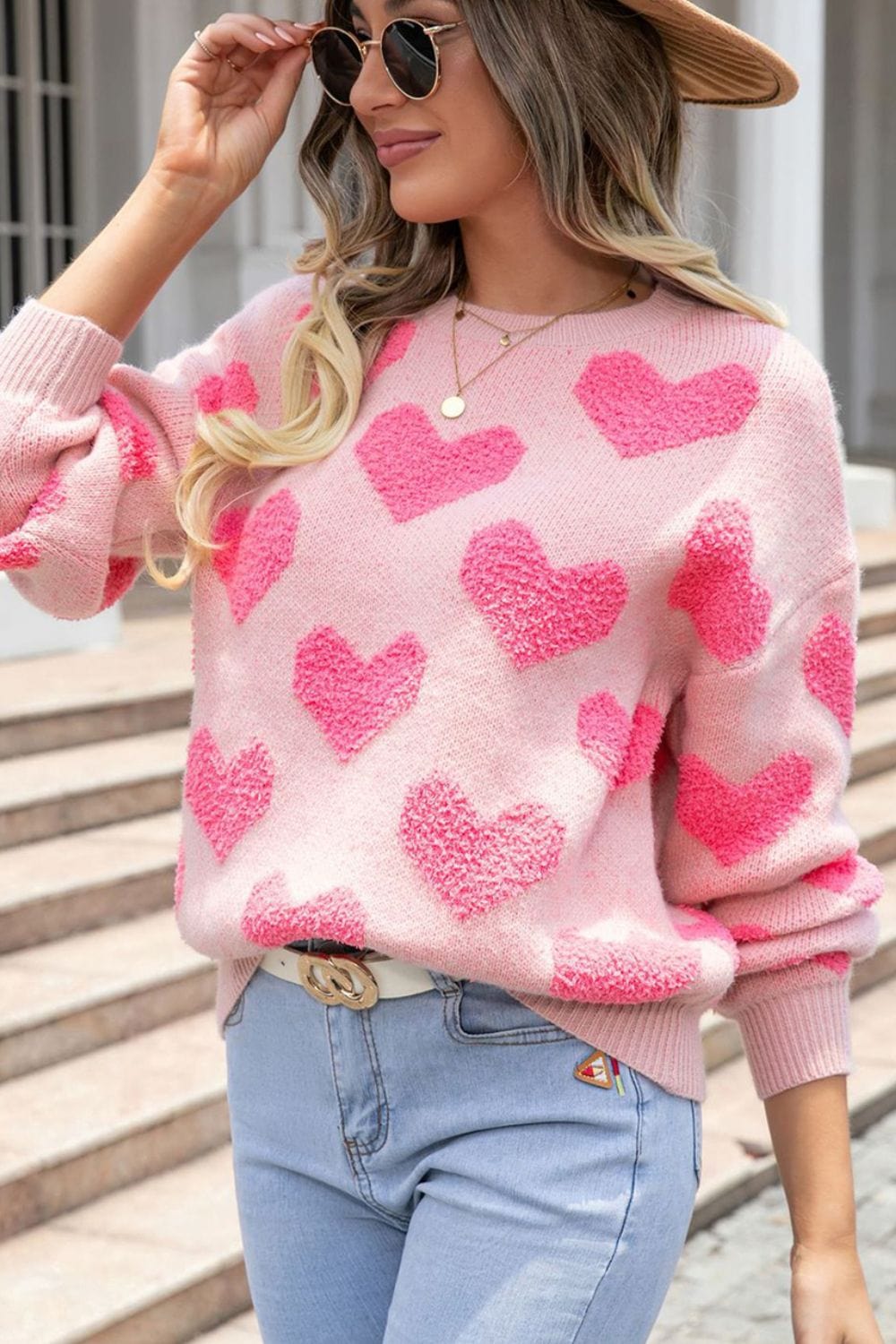 "Heart Jacquard Round Neck Sweater featuring a playful heart pattern, displayed on a mannequin against a neutral backdrop, showcasing its cozy fit and stylish design."