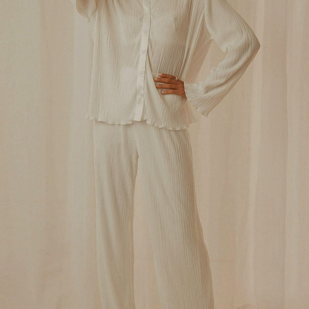 Stylish Collared Neck Long Sleeve Top and Pants Lounge Set featuring a buttoned design in a soft, opaque fabric. The two-piece ensemble is displayed on a neutral background, showcasing its chic and comfortable style, perfect for lounging or casual outings.