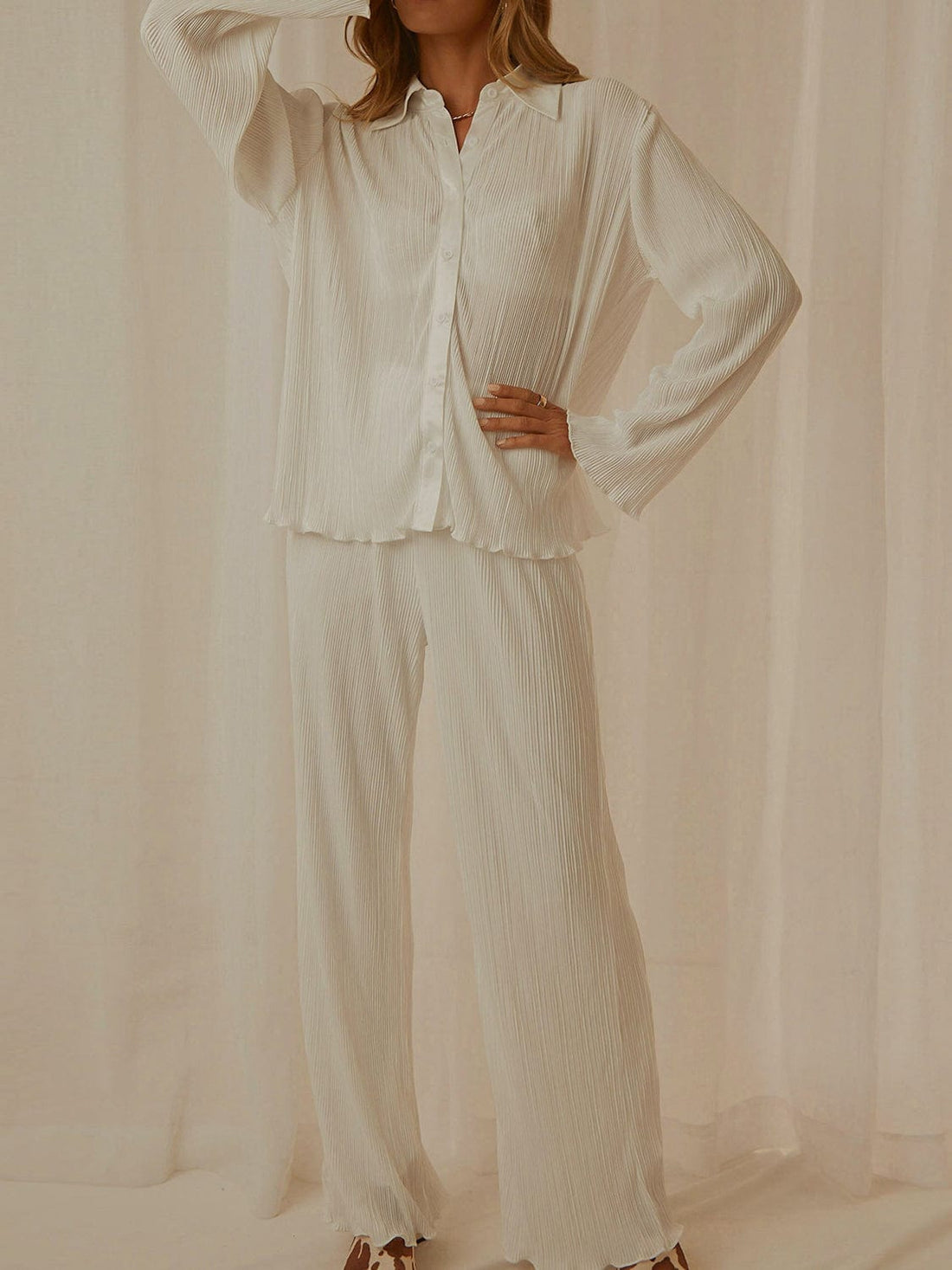 Stylish Collared Neck Long Sleeve Top and Pants Lounge Set featuring a buttoned design in a soft, opaque fabric. The two-piece ensemble is displayed on a neutral background, showcasing its chic and comfortable style, perfect for lounging or casual outings.