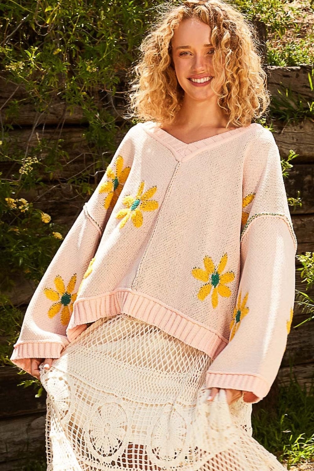 Front view of the V-Neck Floral Pattern Chenille Sweater, featuring a stylish V-neckline, long sleeves, and a relaxed fit. The sweater is made from soft chenille fabric with a luxurious feel, showcasing a unique berber flower print and contrast stitching details, perfect for cozy and fashionable outfits.
