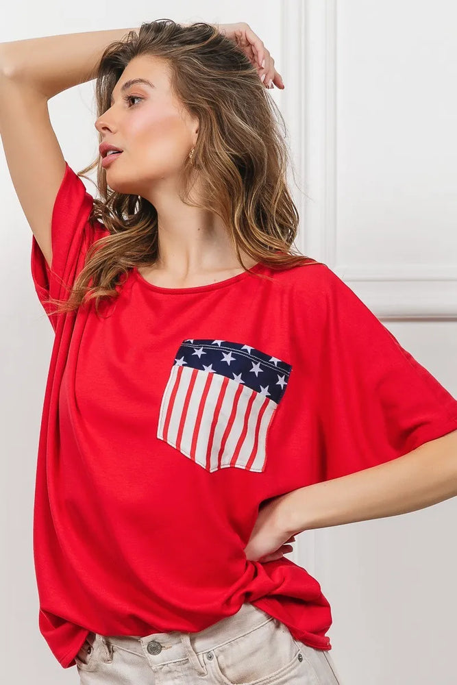 Woman wearing a BiBi French Terry Dolman Sleeve Top with front pocket, relaxed oversized fit, and cozy fabric-perfect for casual, lounge, or athleisure style.

