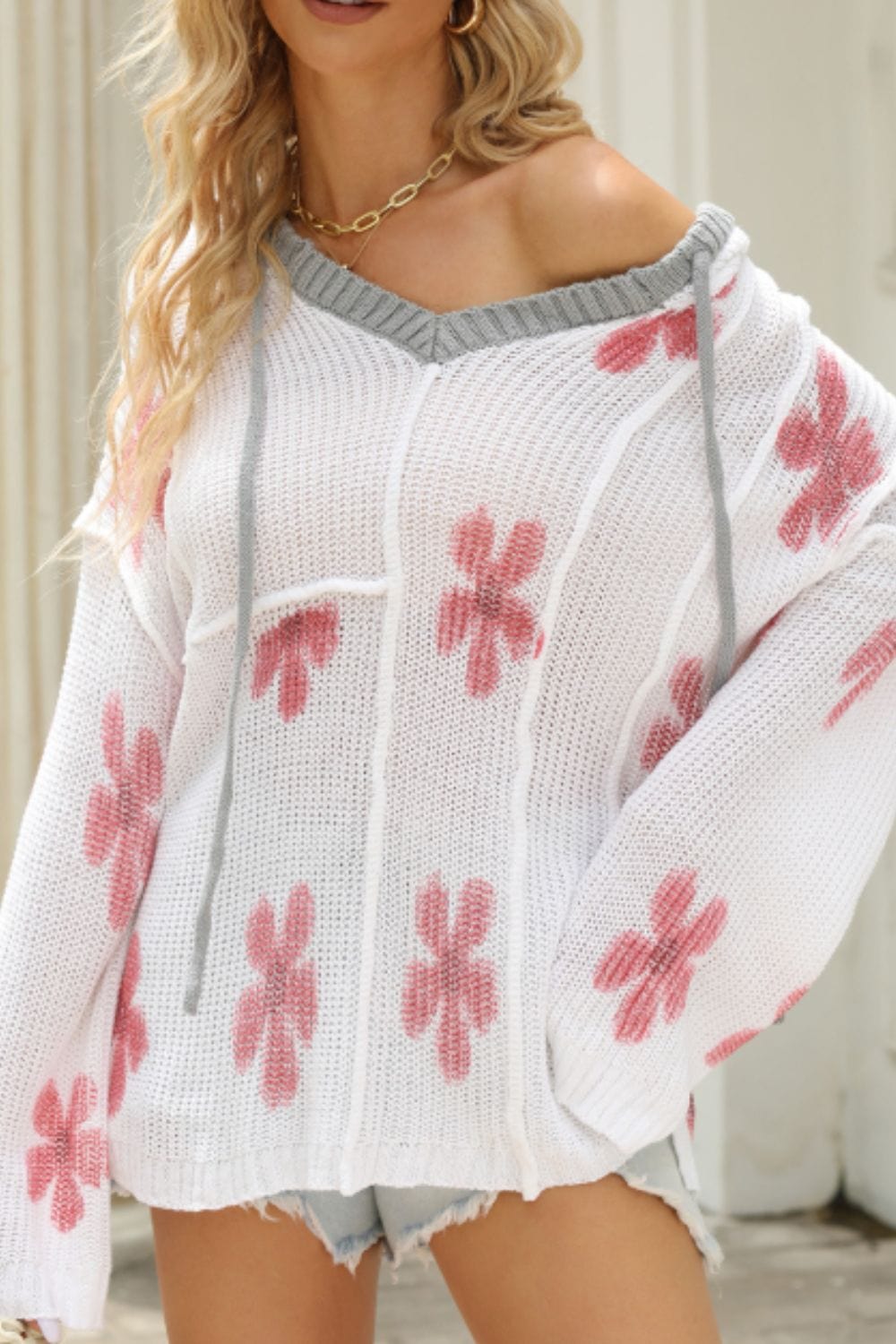 Drawstring Flower Hooded Knit Top featuring a charming floral design, exposed seam details, and a slightly stretchy fit, perfect for casual and comfortable wear.