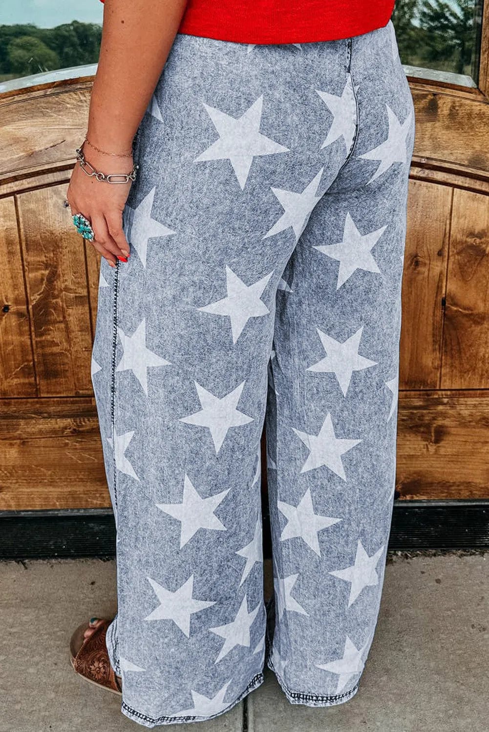 back view 
Drawstring Star Wide Leg Jeans: "Drawstring Star Wide Leg Jeans featuring a relaxed fit, star pattern design, and adjustable drawstring waist, displayed on a model or hanger against a neutral background.