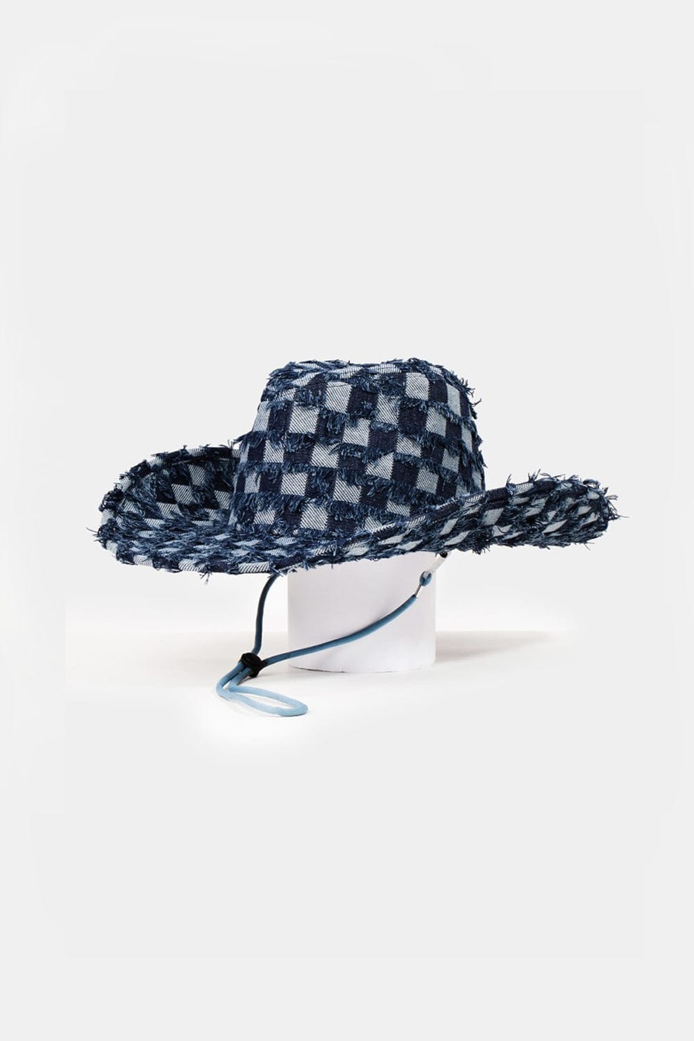 A denim cowboy hat with a checkered fringe, showcasing a unique twist on western fashion by Unique Klture Fame