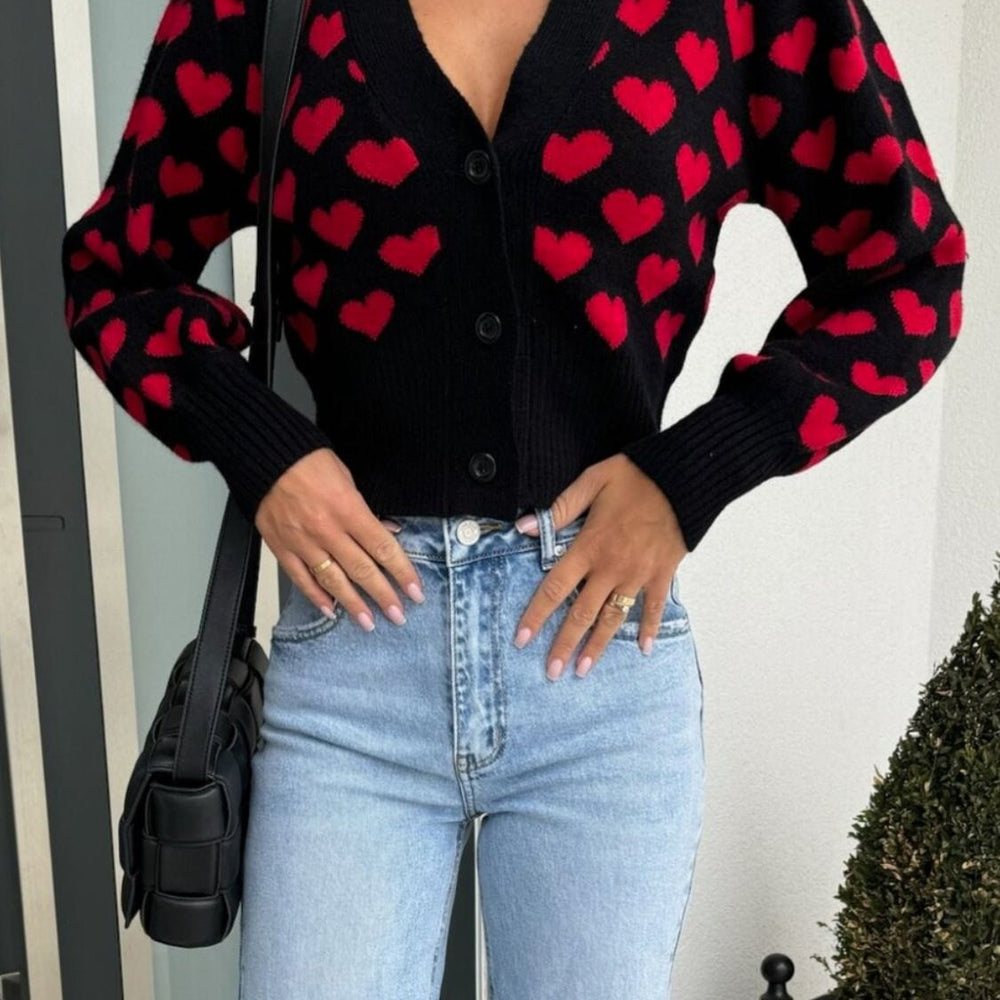 Valentine’s Day Heart V-Neck Cropped Car
digan featuring a playful heart pattern, displayed on a mannequin against a soft background, highlighting its stylish cropped fit and cozy design."