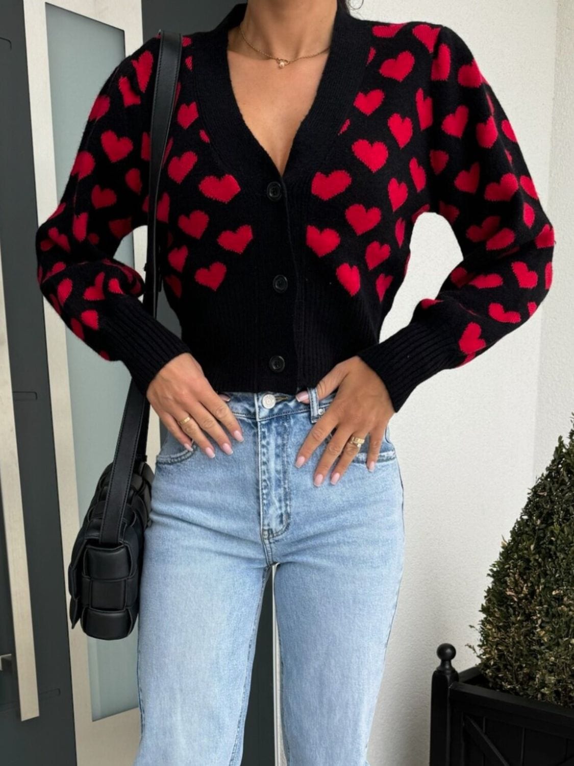 Valentine’s Day Heart V-Neck Cropped Car
digan featuring a playful heart pattern, displayed on a mannequin against a soft background, highlighting its stylish cropped fit and cozy design."