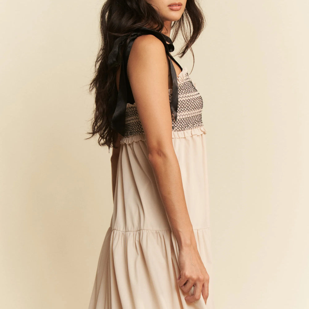 Model wearing a washed raw hem oversized shirt from Unique Kulture, featuring distressed fabric, buttoned front, and pocket details.
close view
