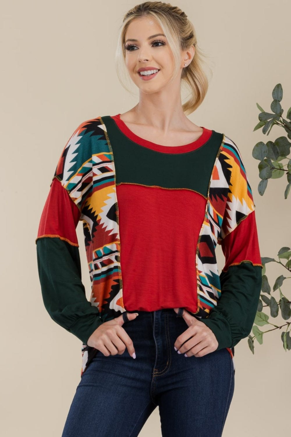 "Front view of the Celeste Full Size Exposed Seam Print Color Block T-Shirt, showcasing its vibrant contrasting colors and modern exposed seam design. The t-shirt features a slightly stretchy fit and an opaque fabric, perfect for a stylish and comfortable casual look
