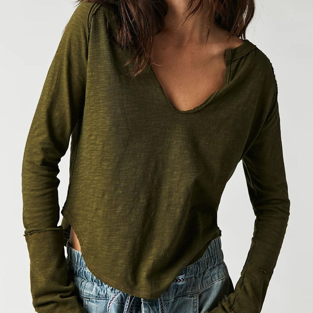 Front view of the Unique Kulture Exposed Seam Notched Long Sleeve T-Shirt, showcasing its modern design with a notched neckline and exposed seam details. The shirt features a relaxed fit and is made from high-quality fabric, perfect for casual wear or making a fashion statement
