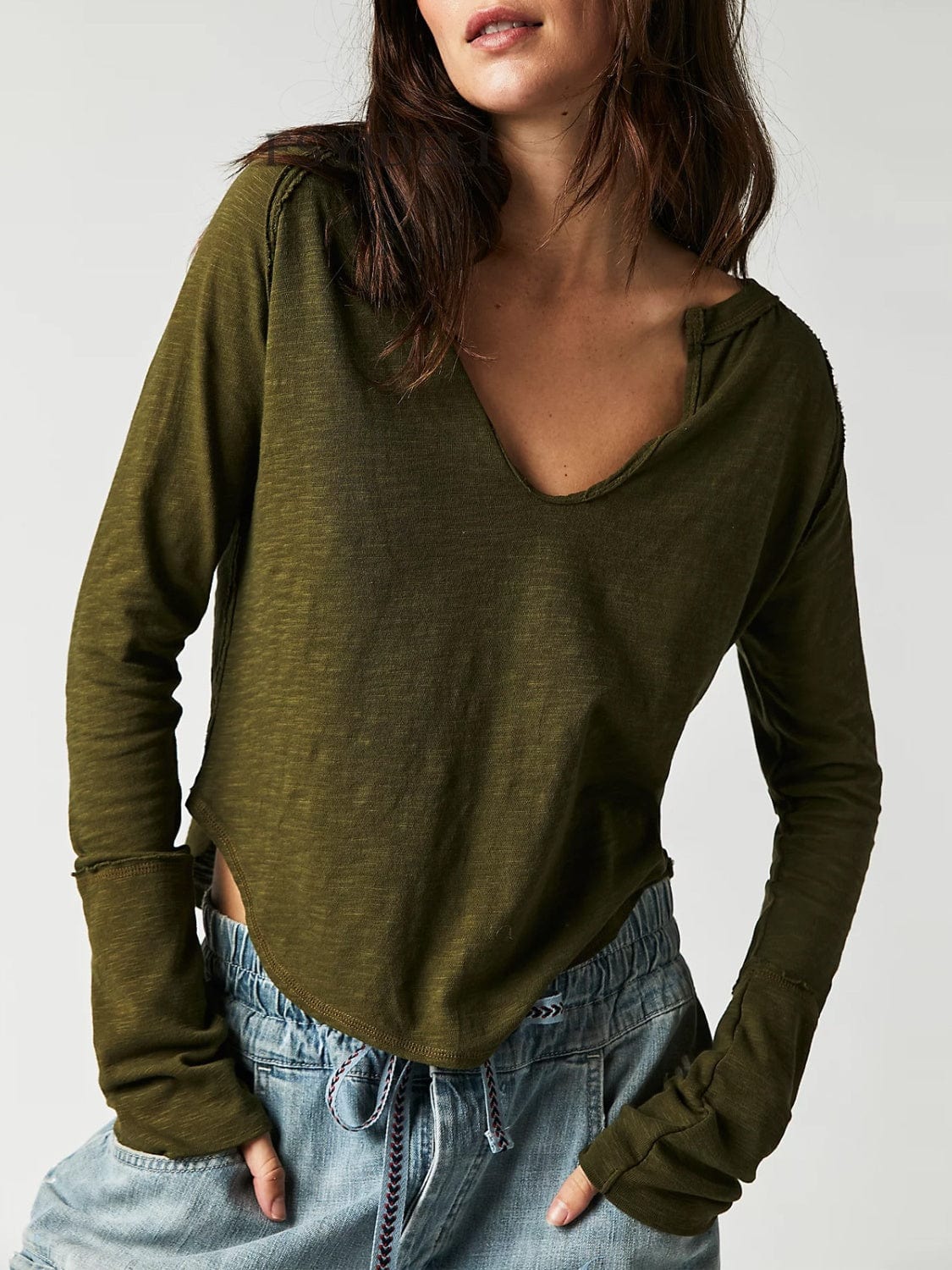 Front view of the Unique Kulture Exposed Seam Notched Long Sleeve T-Shirt, showcasing its modern design with a notched neckline and exposed seam details. The shirt features a relaxed fit and is made from high-quality fabric, perfect for casual wear or making a fashion statement
