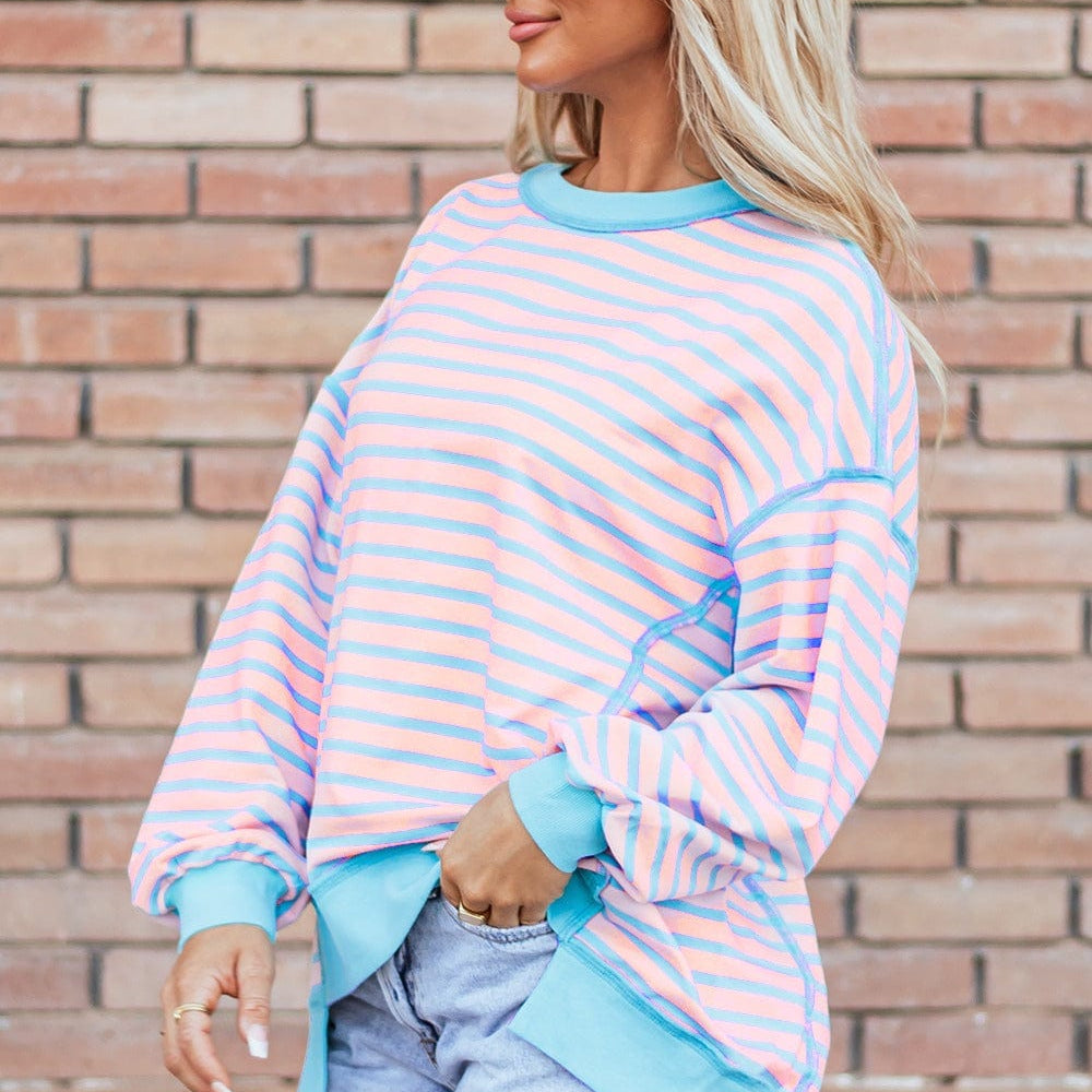 : A stylish Unique Culture High-Low Striped Long Sleeve Sweatshirt featuring a modern high-low hem and a playful striped design. The sweatshirt is displayed against a neutral background, showcasing its comfortable fit and slightly stretchy fabric. Ideal for casual outings or lounging at home, this versatile piece combines chic style with everyday comfort