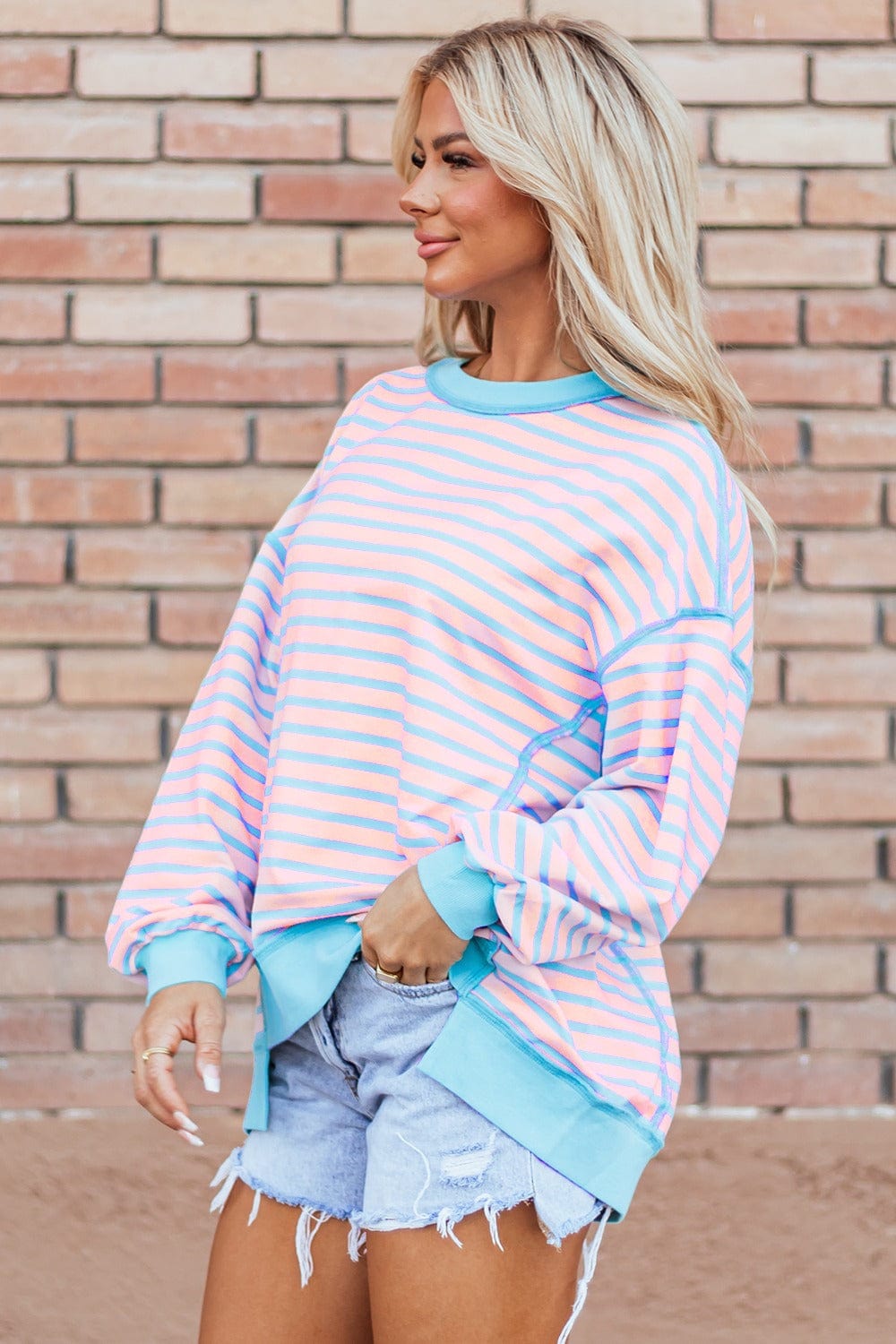 : A stylish Unique Culture High-Low Striped Long Sleeve Sweatshirt featuring a modern high-low hem and a playful striped design. The sweatshirt is displayed against a neutral background, showcasing its comfortable fit and slightly stretchy fabric. Ideal for casual outings or lounging at home, this versatile piece combines chic style with everyday comfort