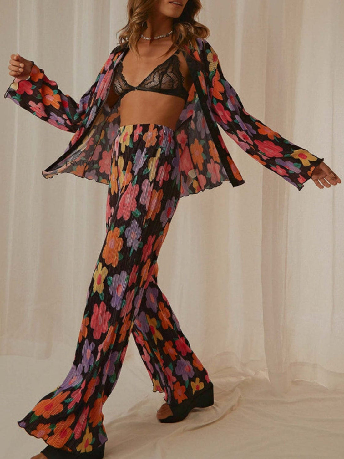 Front view of the Unique Kulture Printed Collared Neck Long Sleeve Top and Pants Lounge Set, featuring a stylish collared neck design and buttoned front. The set includes a long sleeve top and matching pants, showcasing a coordinated look in a comfortable and chic fabric