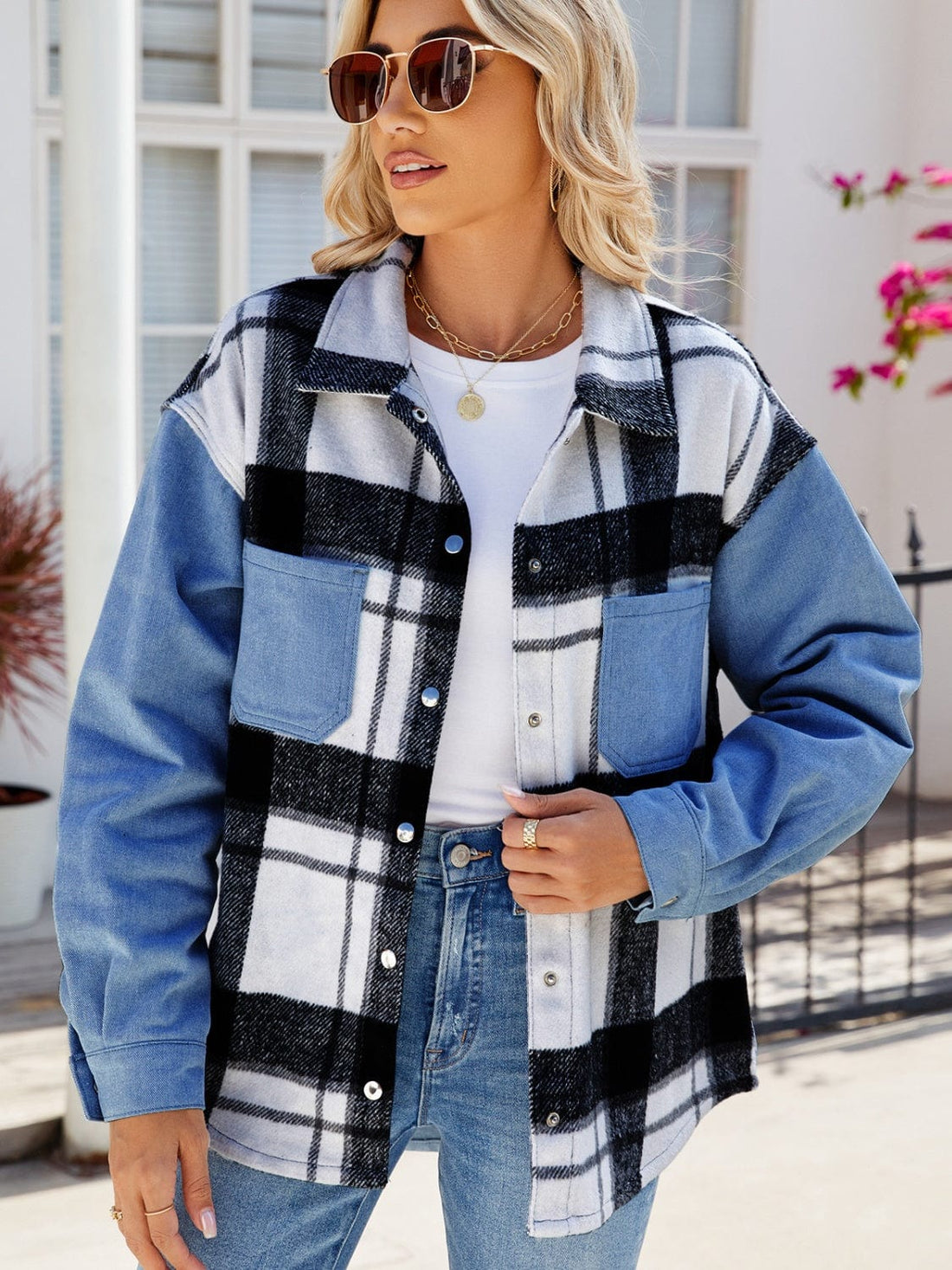 Unique Kulture Pocketed Plaid Snap Down Denim Jacket featuring a stylish plaid pattern and functional snap-down closure. The jacket is displayed in a casual setting, highlighting its pockets and versatile design, perfect for layering over various outfits.
