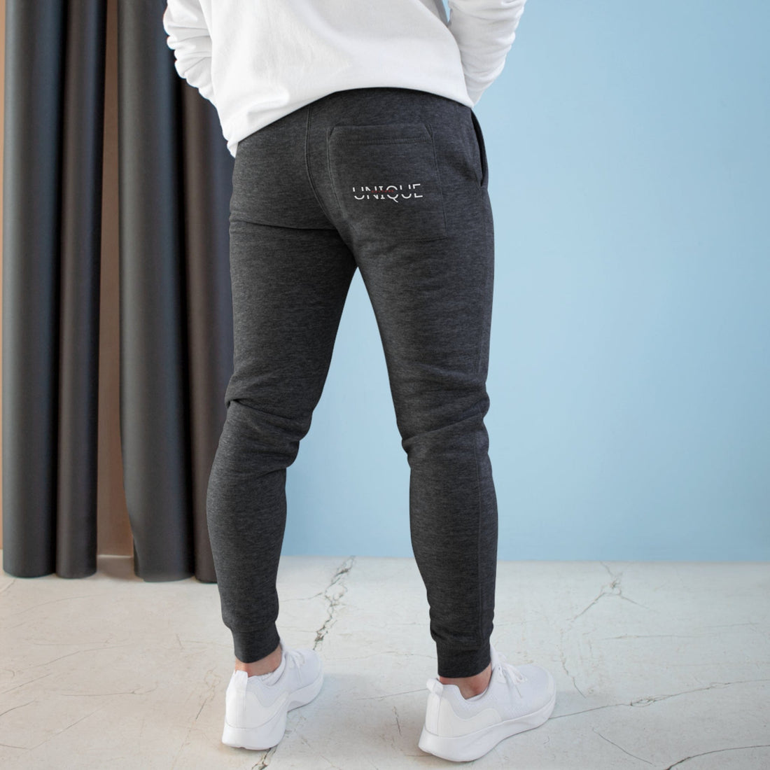 Unique Kulture Designer Fleece Joggers - Unisex, premium-quality joggers made from a soft blend of 80% combed ringspun cotton and 20% polyester in a medium-heavy fabric weight (8.25 oz/yd²). Features two spacious side pockets, a customizable back pocket, soft 3-end fleece construction, and ribbed bottom and waistband cuffs for a secure fit. Perfect for an active lifestyle or lounging, these stylish and comfortable joggers offer a customizable back pocket for personalization.