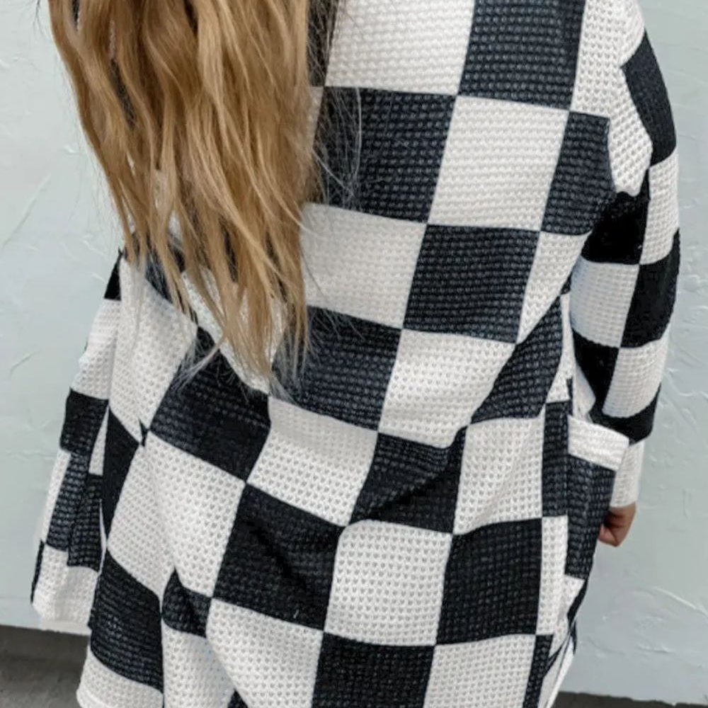 Unique Kulture Checkered Open Front Long Sleeve Cover Up displayed on a mannequin, featuring a stylish checkered pattern, open front design, and long sleeves. The lightweight cover-up is perfect for layering over swimwear or casual outfits, showcasing a relaxed and fashionable look.