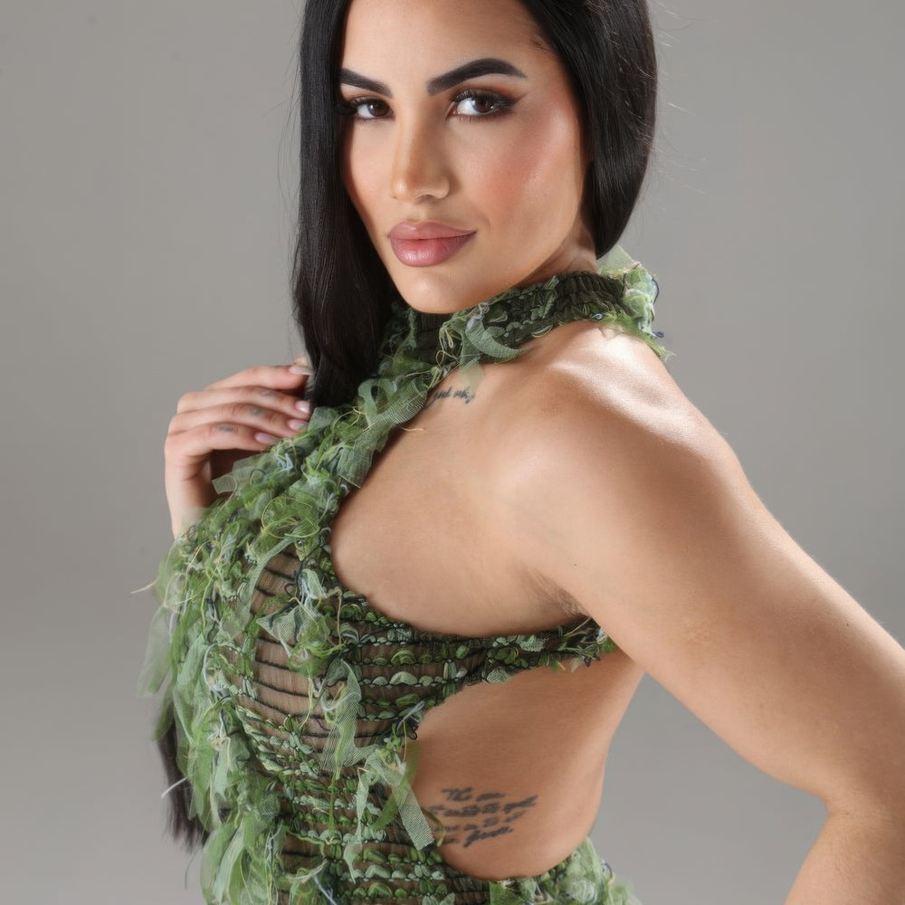 
                  
                    Model wearing Unique Kulture blue halter ruffled dress with open back and multi-ruffles


                  
                