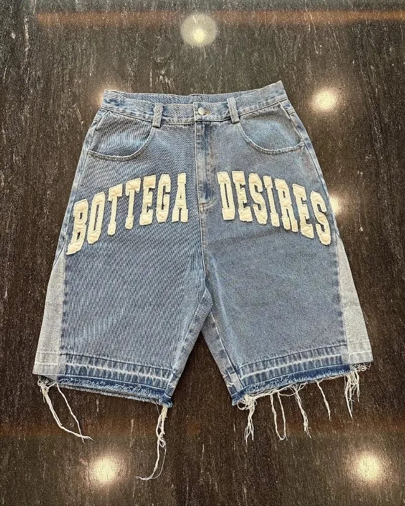  A close-up image displaying Bottega Desires Designer Jean Shorts. The shorts feature intricate stitching details, subtle distressing, and a classic denim wash. The high-quality denim fabric is evident, showcasing its softness and durability. These shorts exude a sense of casual elegance, perfect for summer outings and relaxed occasions