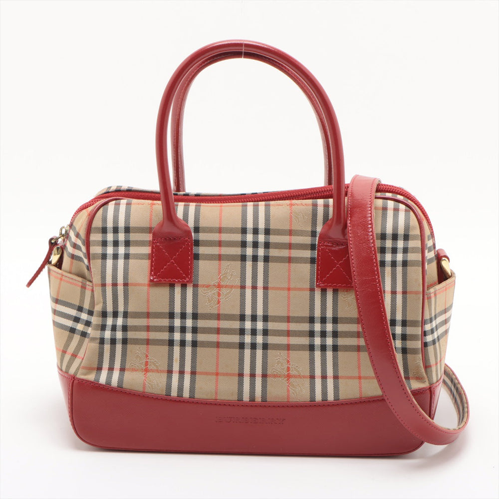 Designer handbag with plaid pattern and red accents on a white background