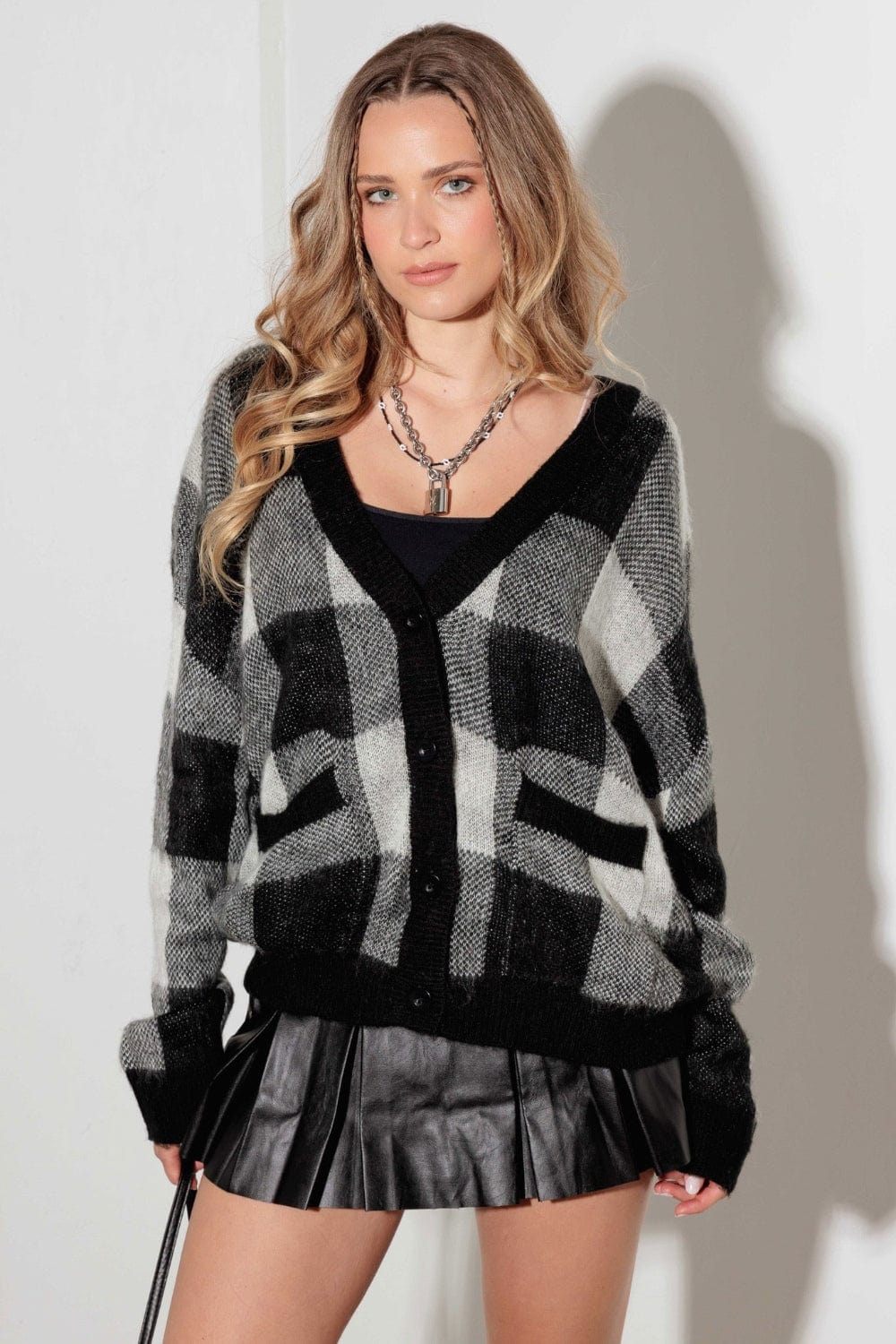 Mustard Seed V-Neck Checkered Cardigan with Pockets, featuring a stylish checkered pattern and a flattering V-neck design. The cardigan is shown in a cozy fabric, highlighting its functional pockets and versatile style, perfect for layering over tops or dresses