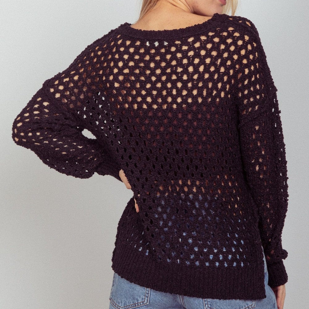 A knit cover-up by Unique Kulture featuring a stylish slit design, perfect for layering over swimwear or casual outfits."