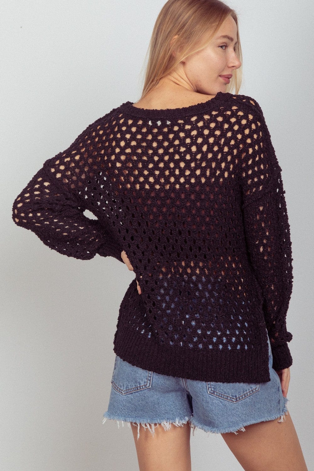 A knit cover-up by Unique Kulture featuring a stylish slit design, perfect for layering over swimwear or casual outfits."
