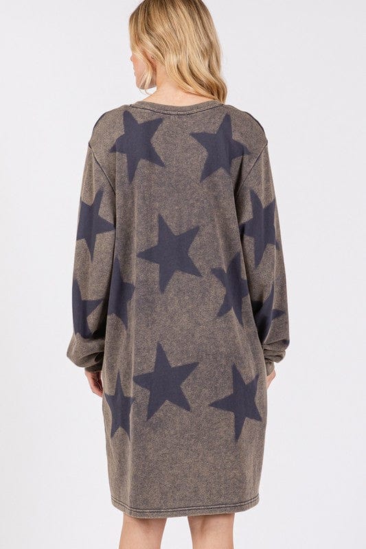  wearing the SAGE + FIG Washed Star Print Round Neck Dress, showcasing its playful star pattern and relaxed fit, set against a soft, neutral background.