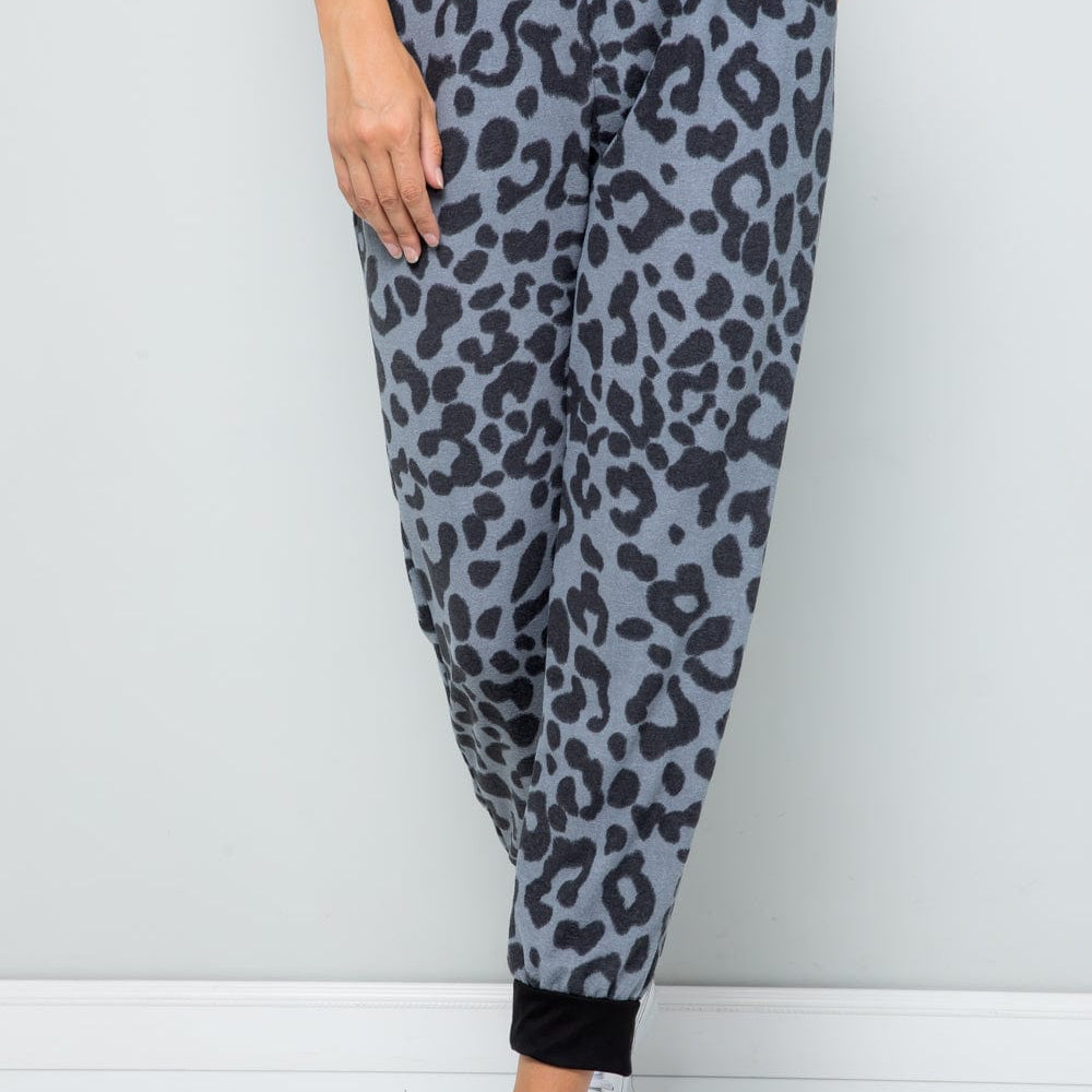 Unique Kulture Celeste Full Size Leopard Contrast Sweatpants featuring a trendy leopard print design with contrasting details. The sweatpants are displayed in a casual setting, highlighting their comfortable fit and stylish appeal, perfect for lounging or casual outings.