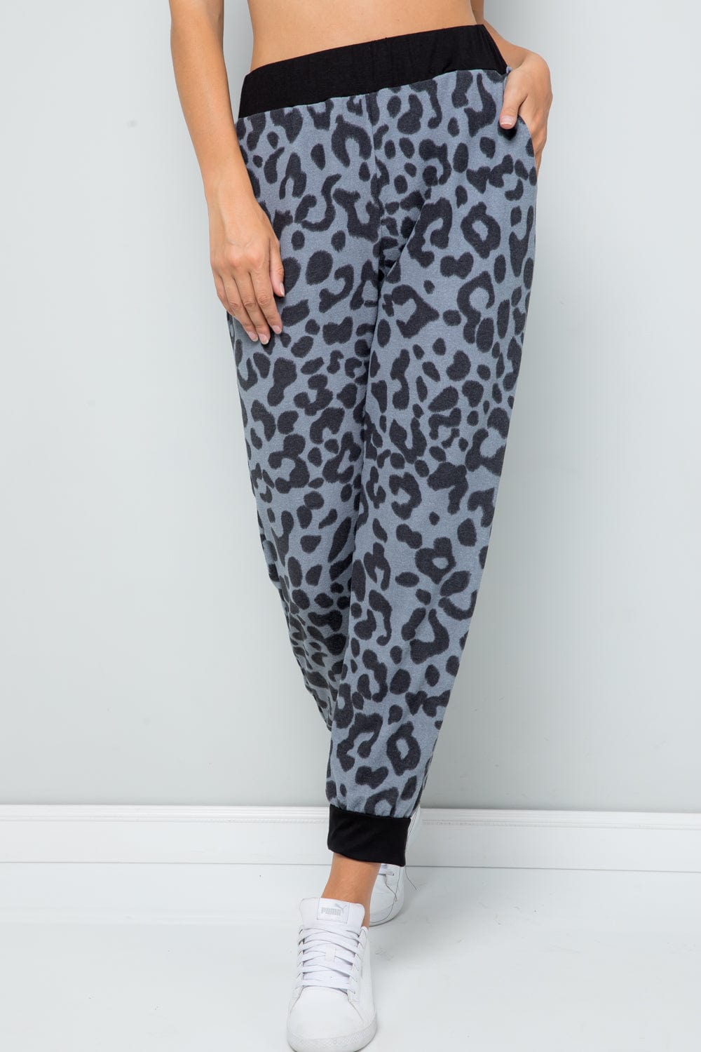 Unique Kulture Celeste Full Size Leopard Contrast Sweatpants featuring a trendy leopard print design with contrasting details. The sweatpants are displayed in a casual setting, highlighting their comfortable fit and stylish appeal, perfect for lounging or casual outings.