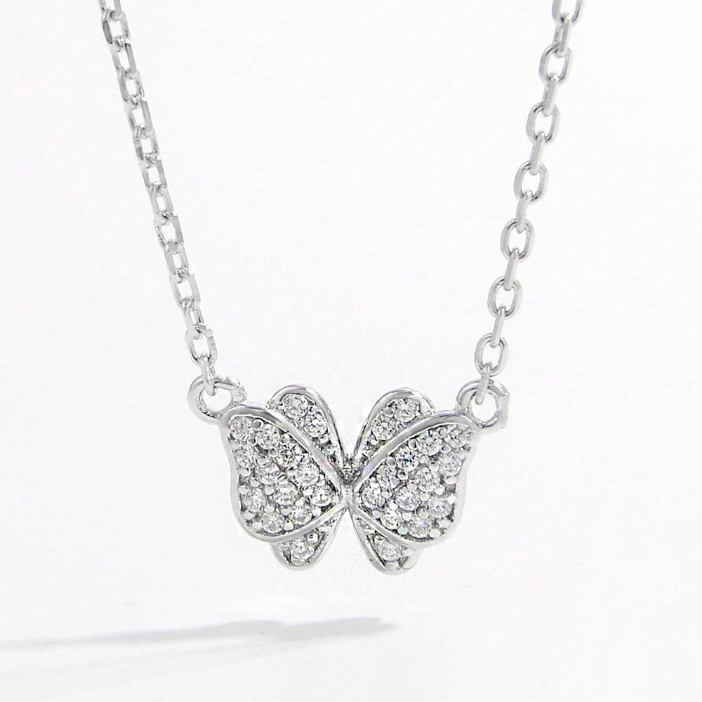 925 Sterling Silver Zircon Butterfly Pendant Necklace. The pendant is crafted in the shape of a butterfly and adorned with sparkling zircon gemstones. The necklace chain complements the pendant, showcasing its delicate beauty. This accessory exudes elegance and charm, perfect for adding a touch of sophistication to any outfit.