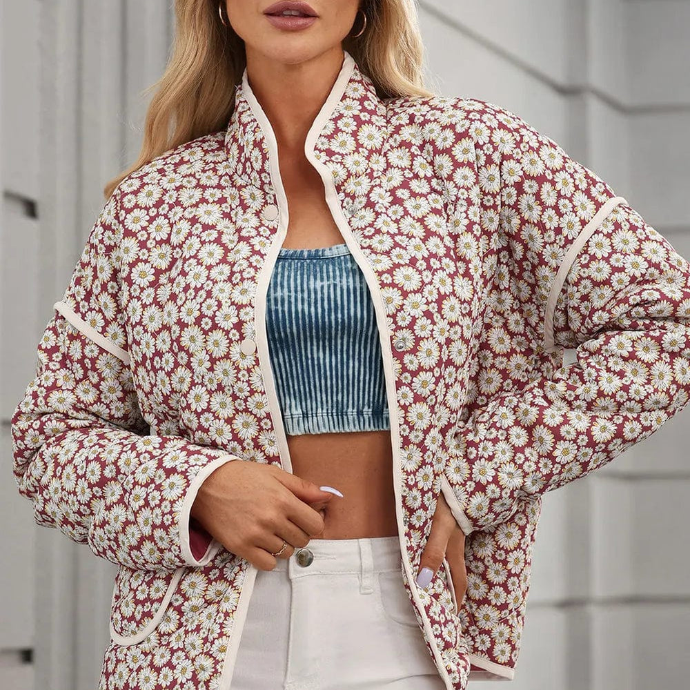 e Floral Snap Down Mock Neck Coat: "Floral Snap Down Mock Neck Coat featuring a vibrant floral pattern, mock neck design, and convenient pockets, displayed on a hanger against a neutral background