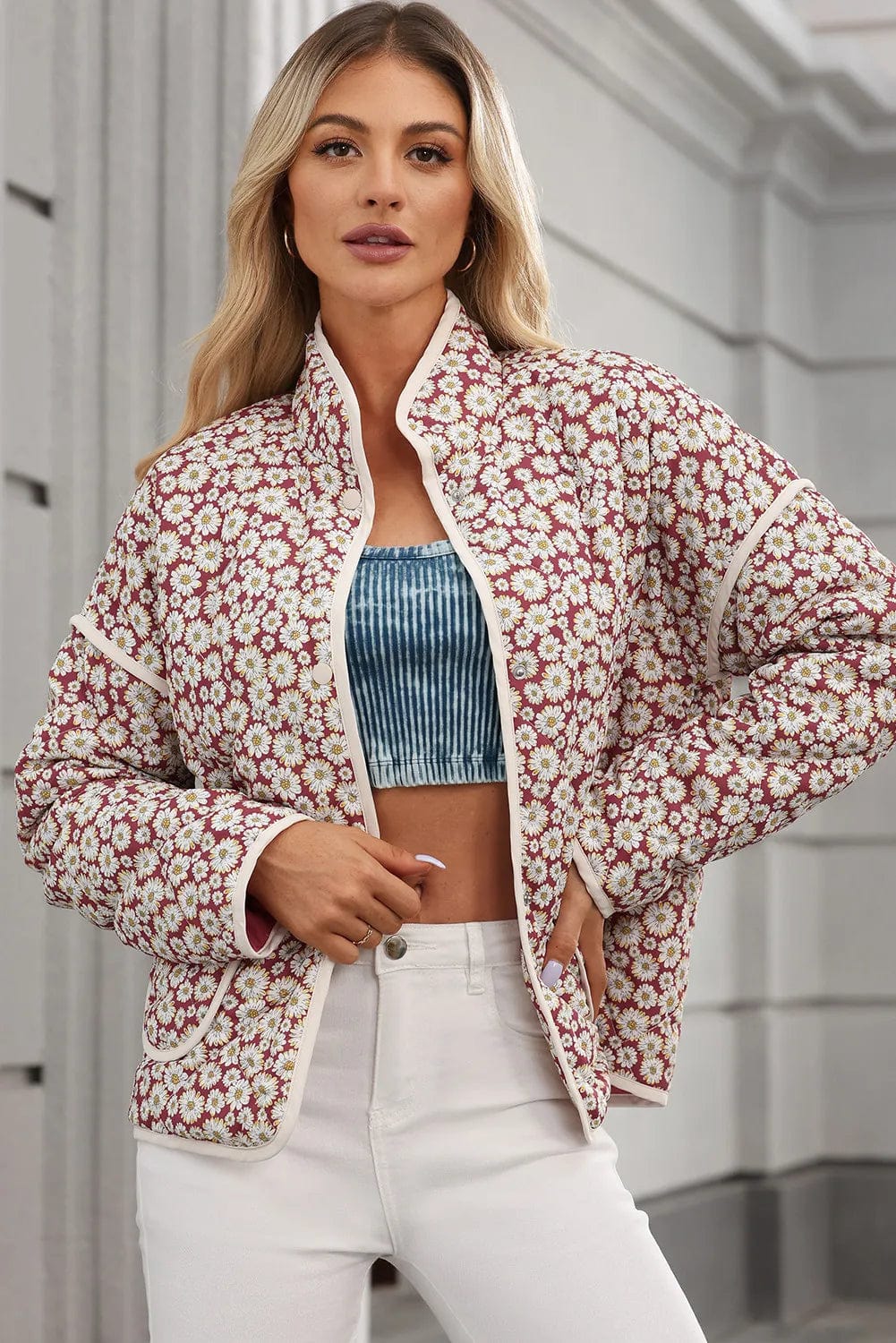 e Floral Snap Down Mock Neck Coat: "Floral Snap Down Mock Neck Coat featuring a vibrant floral pattern, mock neck design, and convenient pockets, displayed on a hanger against a neutral background