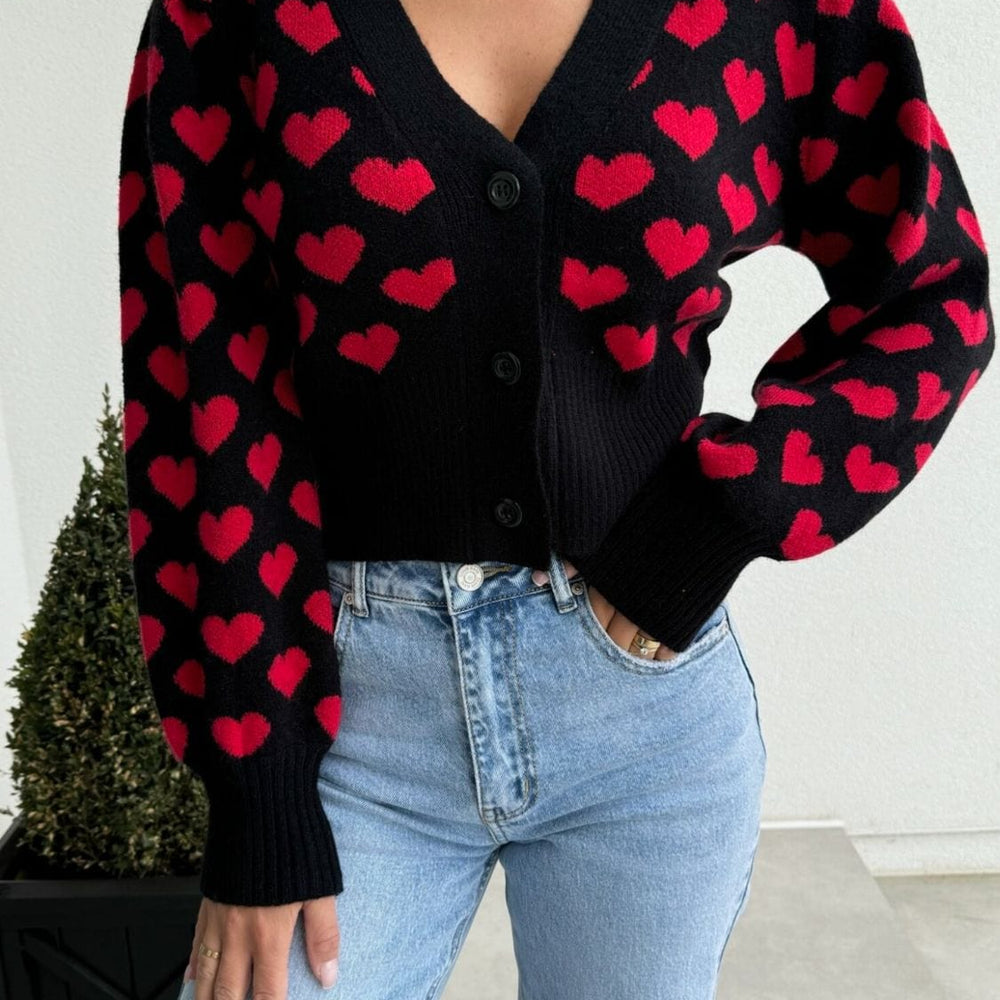 Valentine’s Day Heart V-Neck Cropped Cardigan featuring a playful heart pattern, displayed on a mannequin against a soft background, highlighting its stylish cropped fit and cozy design."
