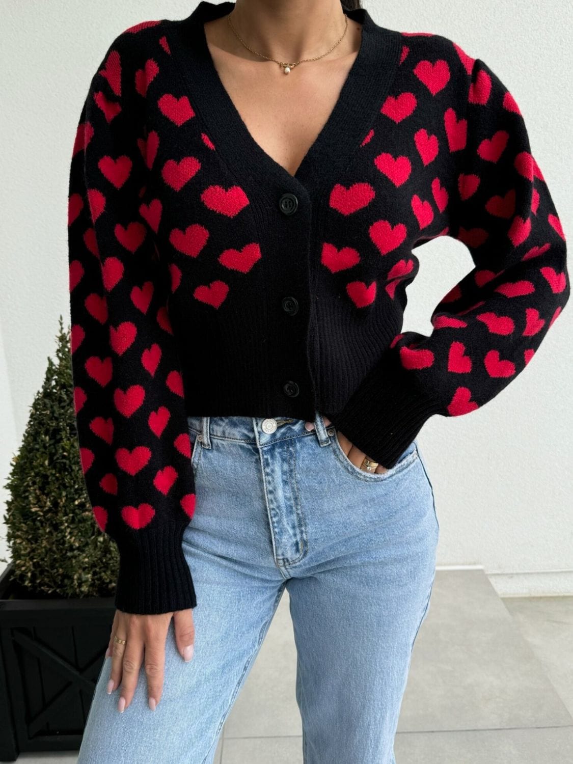 Valentine’s Day Heart V-Neck Cropped Cardigan featuring a playful heart pattern, displayed on a mannequin against a soft background, highlighting its stylish cropped fit and cozy design."
