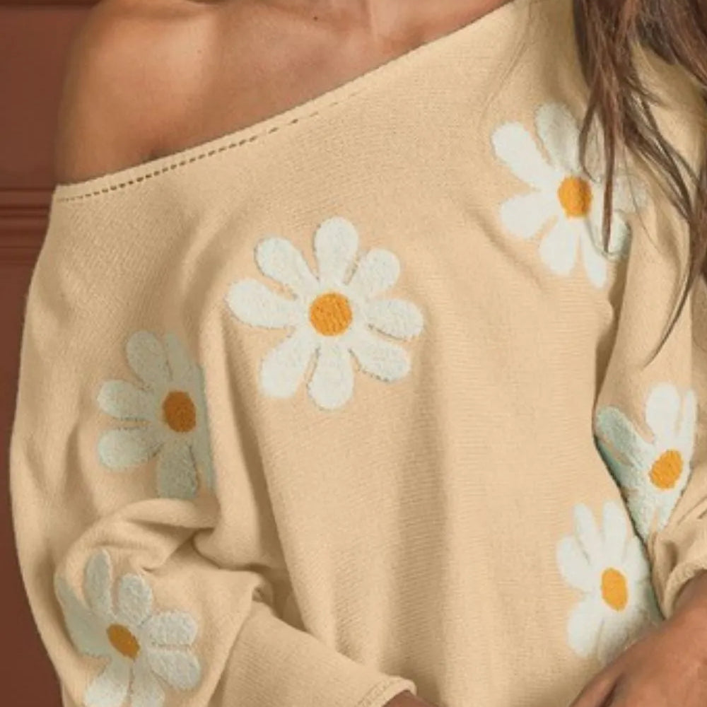 Woman wearing a BiBi Flower Embroidery Loose Fit Knit Top with delicate floral embroidery, relaxed fit, and soft knit fabric-perfect for boho spring and summer style.

