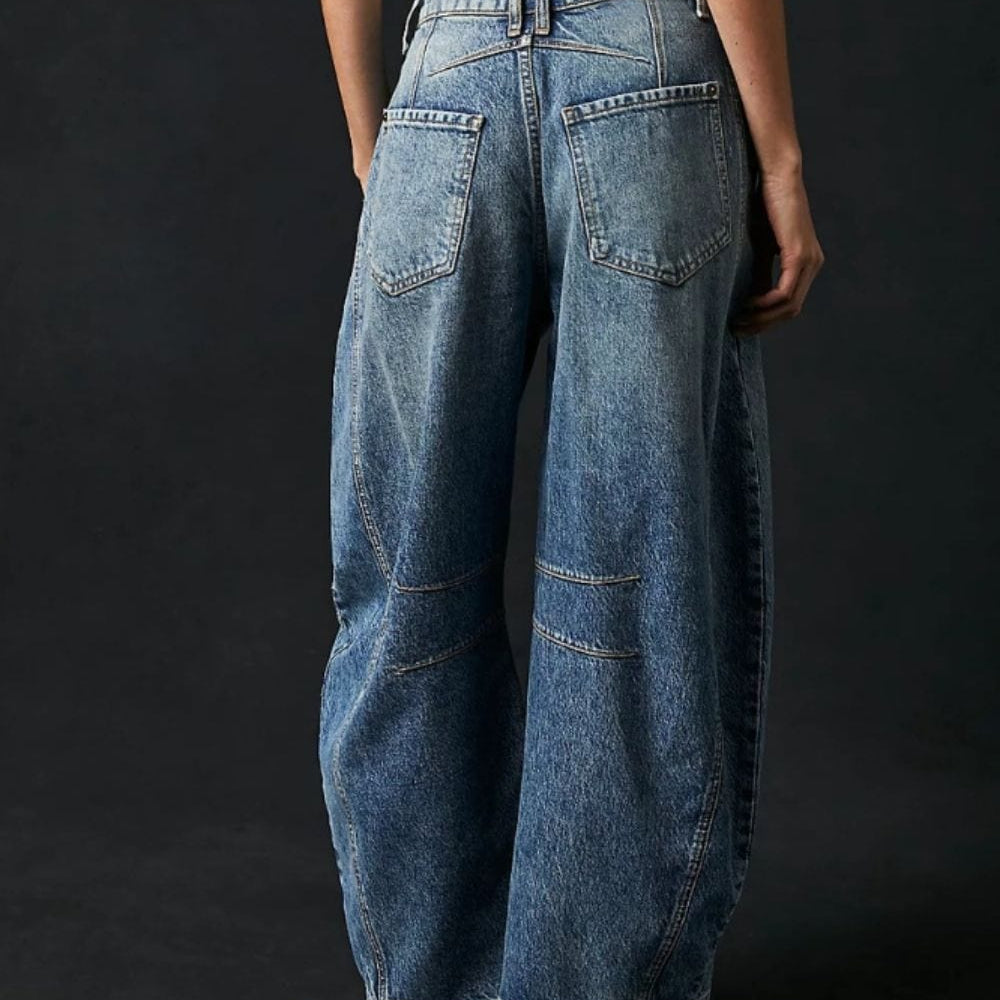 Front view of the Unique Kulture Candy Wide Leg Jeans with Pockets, featuring a classic buttoned closure, a flattering wide leg silhouette, and practical pockets. The jeans are made from a high-quality blend of cotton and polyester, showcasing a stylish and comfortable design perfect for everyday wear.
