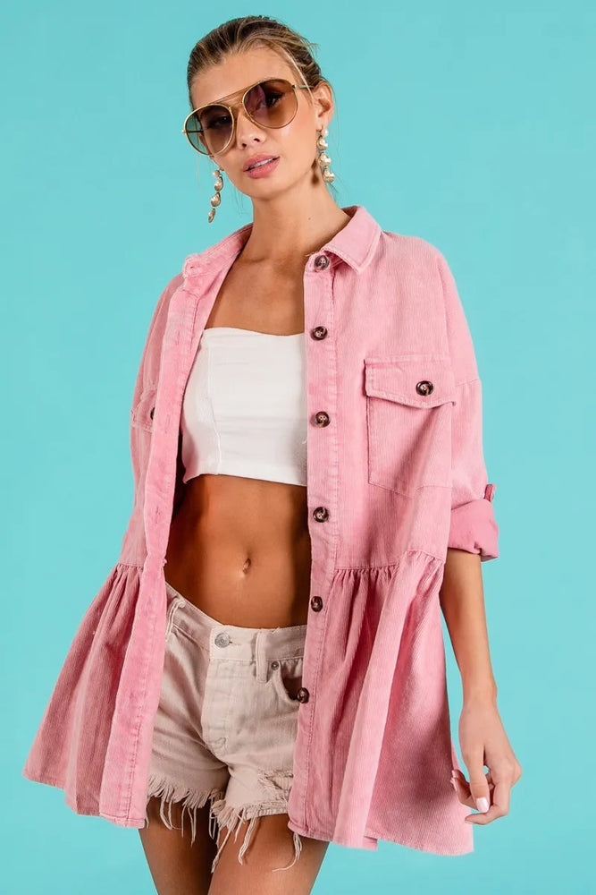 Woman wearing an eco-friendly corduroy ruffle peplum button-up shirt from Unique Kulture, featuring a feminine hem and front pocket.


