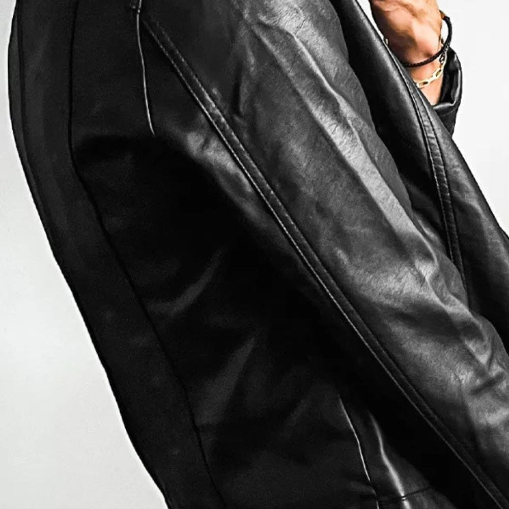 side view of the Unique Kulture PU Leather Round Neck Long Sleeve Jacket, featuring a sleek design made from 100% PU leather. The jacket includes a round neckline, long sleeves, and practical pockets, with a lined interior for added comfort and warmth